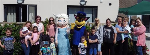 Tenants of Cwrt Col-Huw with mascots Elsa and Chase at the anniversary celebration