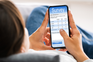 Photo of a person completing an online survey on their phone