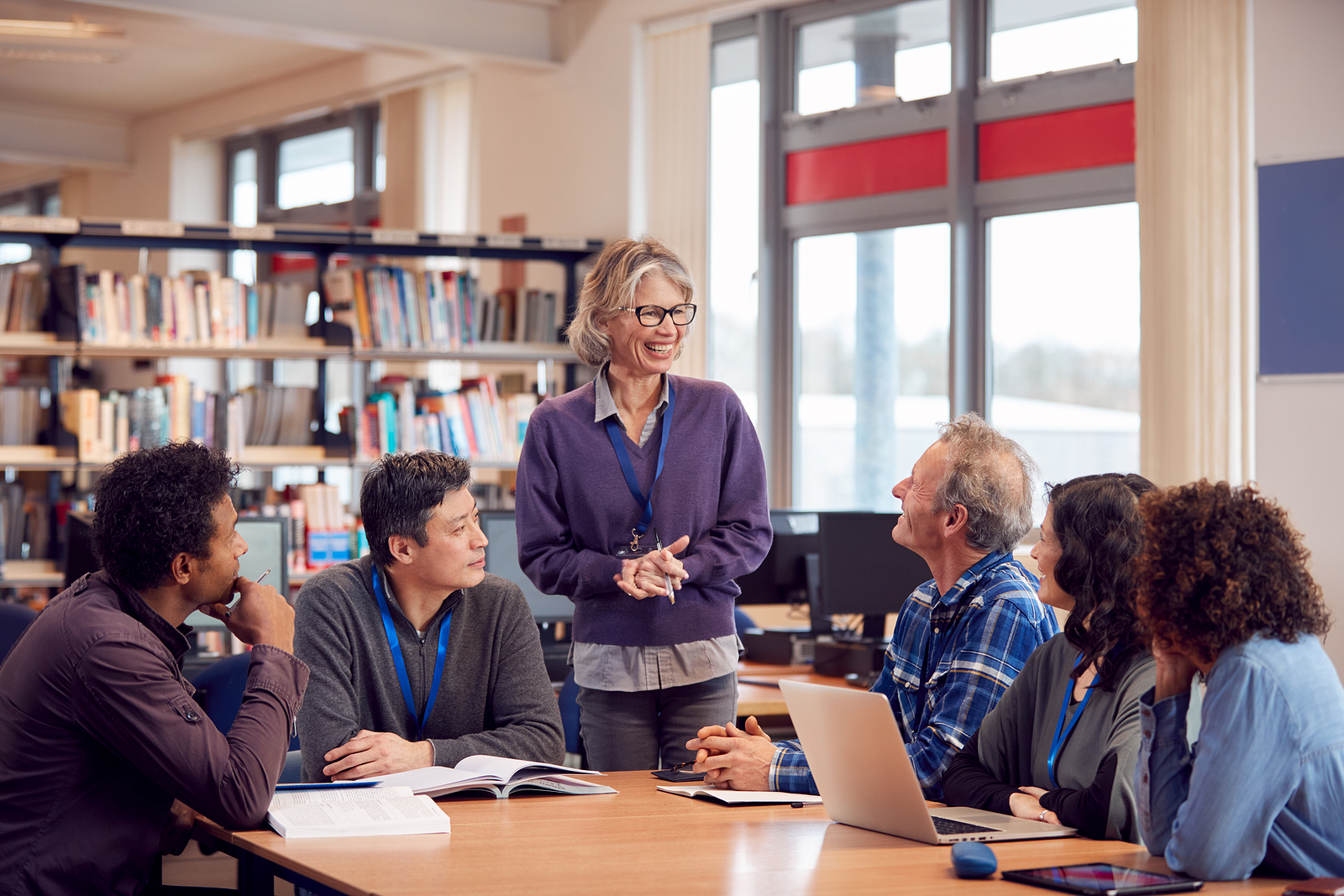 A group of learners listening to a tutor