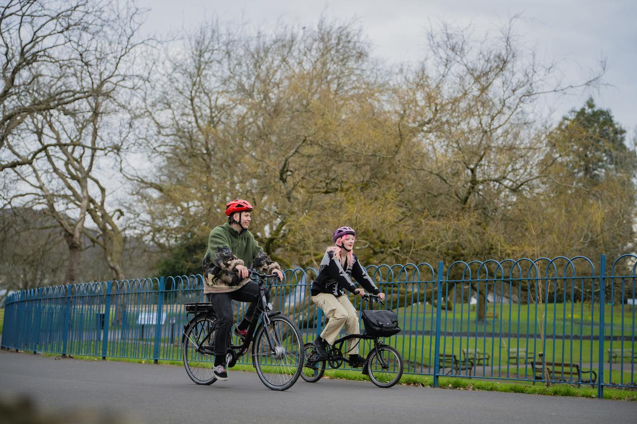 AT - cyclists next to a park