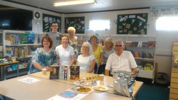 Kyra Kramer with volunteers and library members