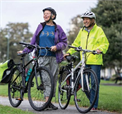 Image of two women stood next to bikes