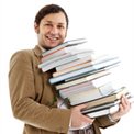 Man carrying a pile of books