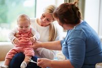 Two women talking with child