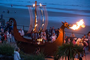 A fire breathing dragon boat on the promenade
