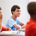 Boy sat at desk in class