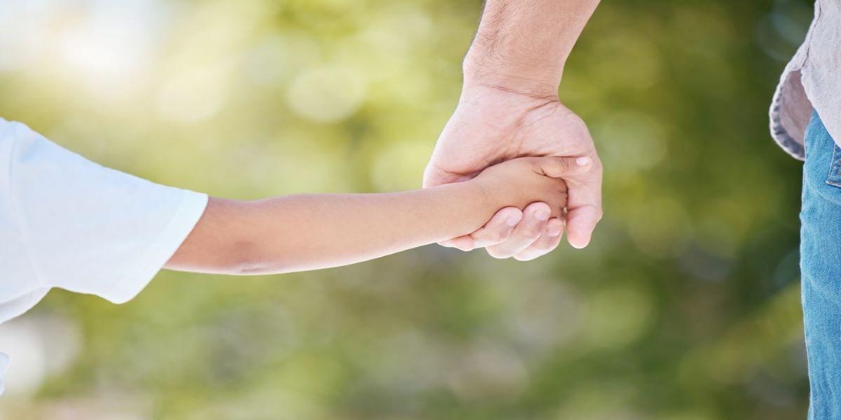 Close up of parent and child holding hands