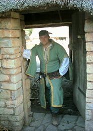 Walter the reeve in the doorway to his cottage