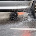 Car driving through surface water